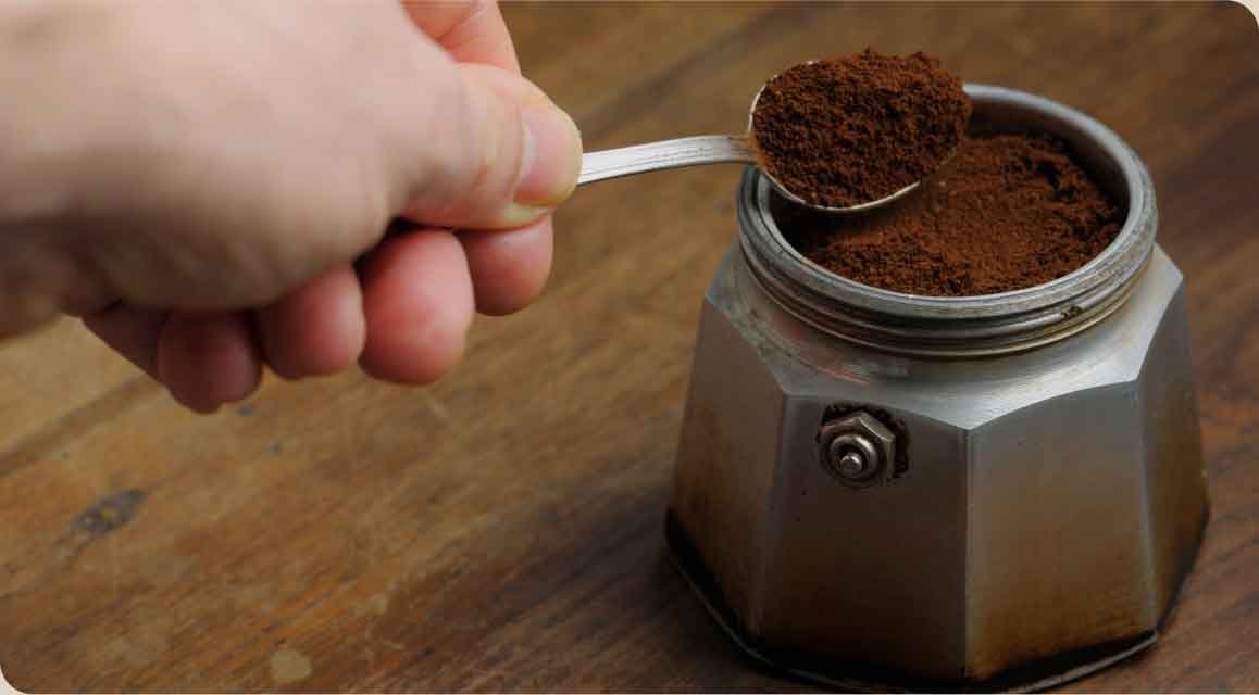 Coffee grounds inside a manual grinder highlighting why you cannot regrind coffee.