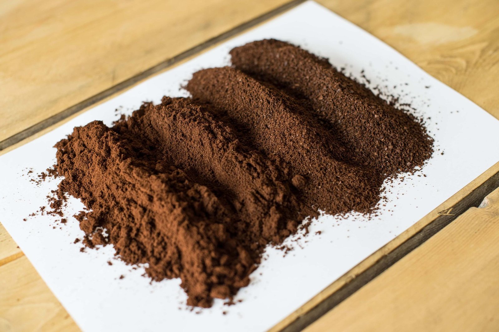Fresh coffee grounds sitting on a wooden table for a perfect morning brew.