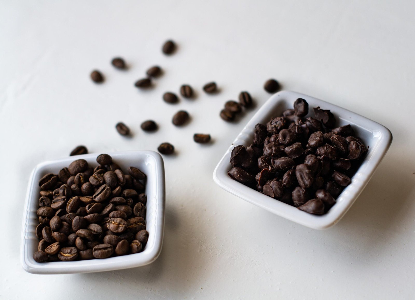 A small jar of coffee grounds on a desk near a notebook.