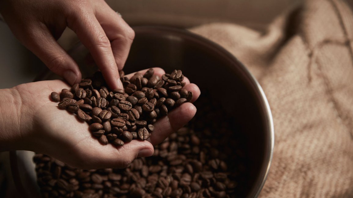 An elegant bowl of roasted coffee grounds on a modern kitchen countertop.
