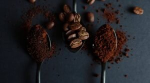 Different textures of coffee grounds displayed on a white surface for brewing coffee.