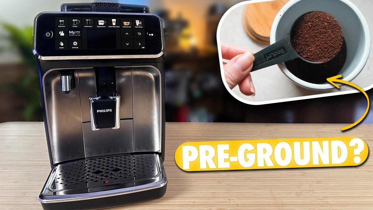 A person uses a small brush to clean leftover grounds from a coffee grinder.