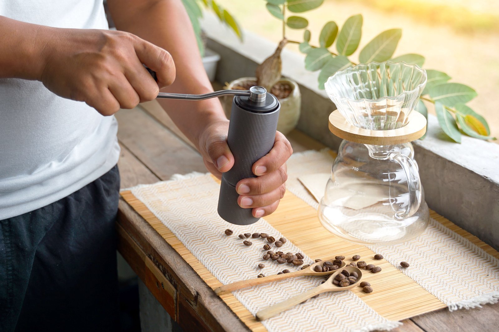A collection of coffee equipment arranged on a marble surface showing how to grind coffee.