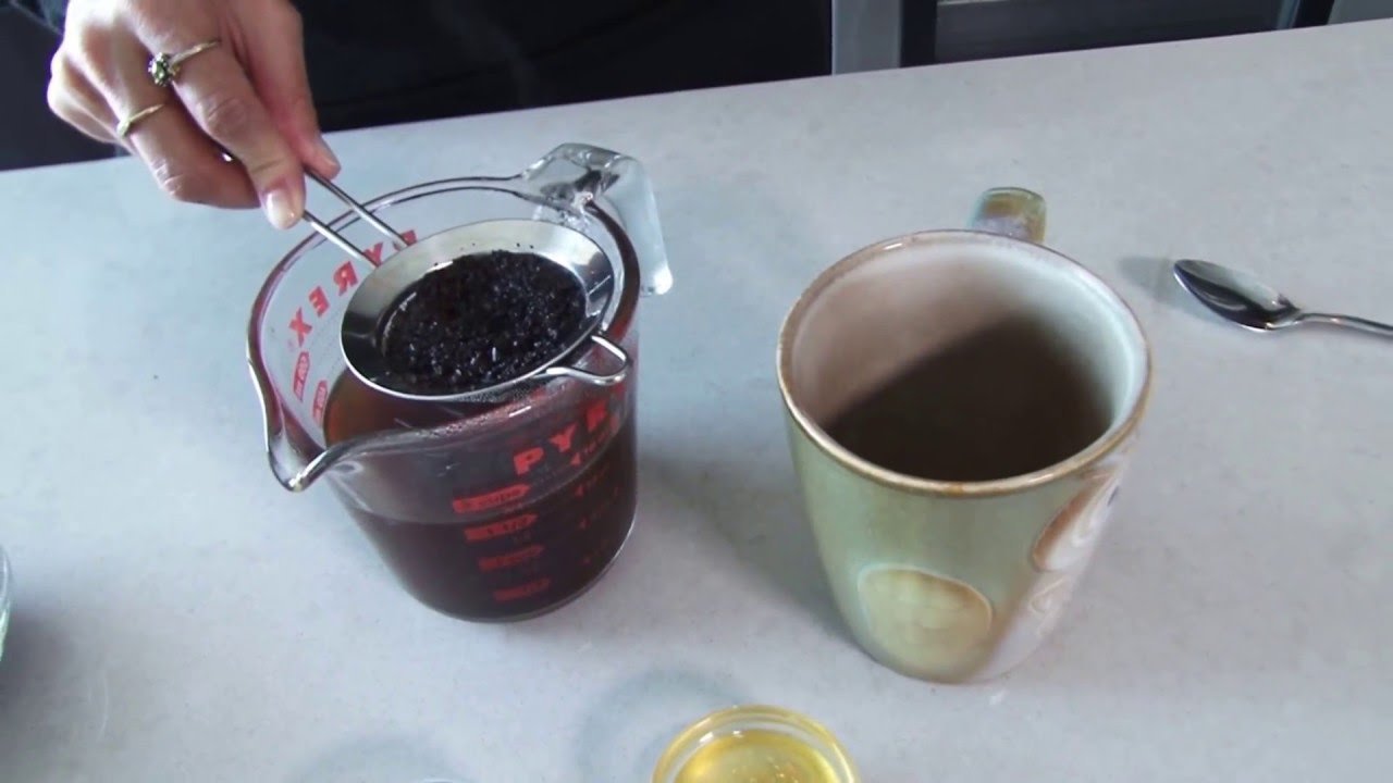 Close up of someone adjusting a grinder to answer common ground coffee questions.