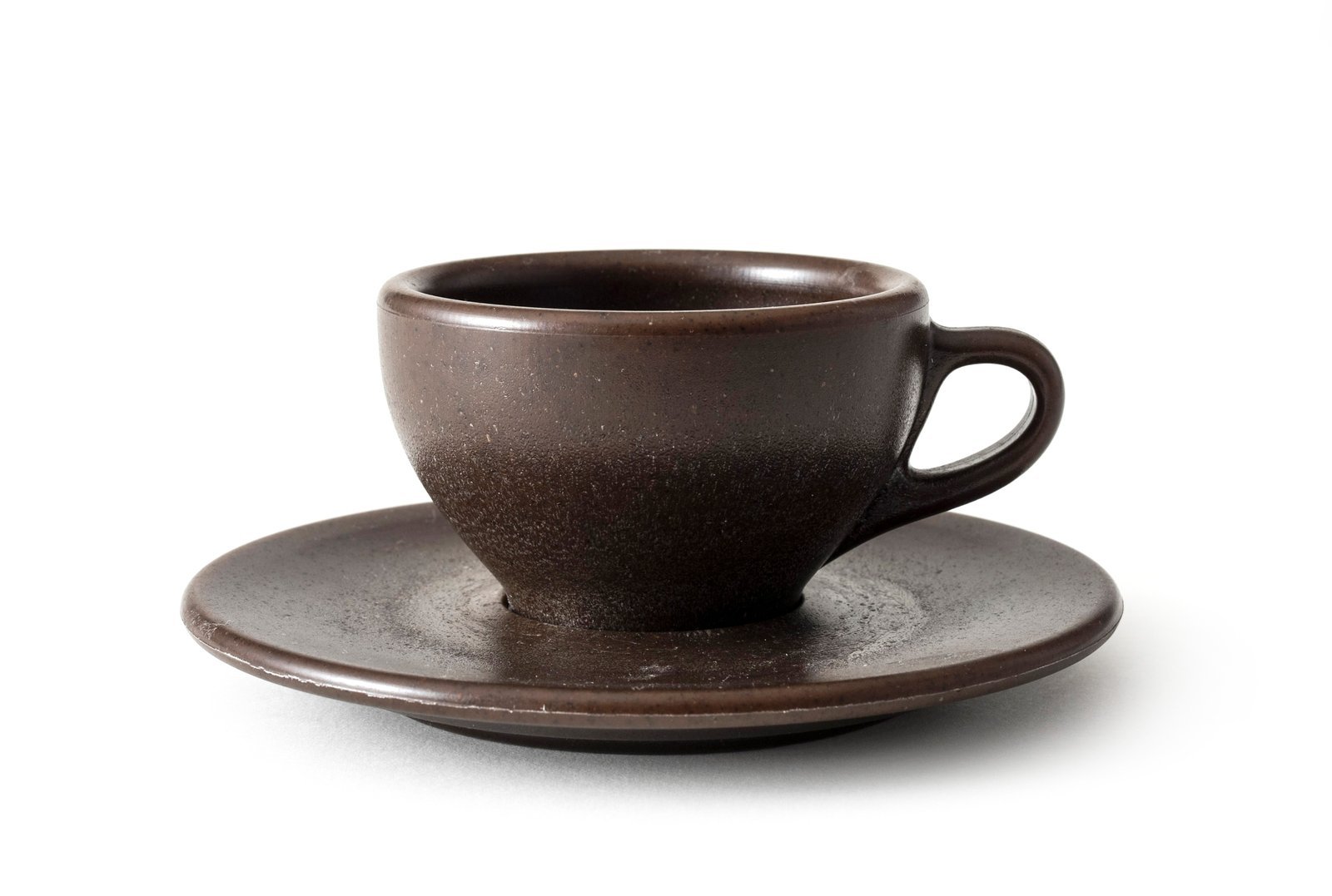 Freshly ground coffee being poured into a glass carafe for brewing.