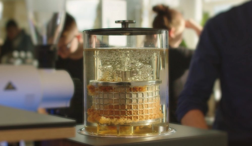 A glass carafe of cold brew coffee showing the clarity of the extraction method.