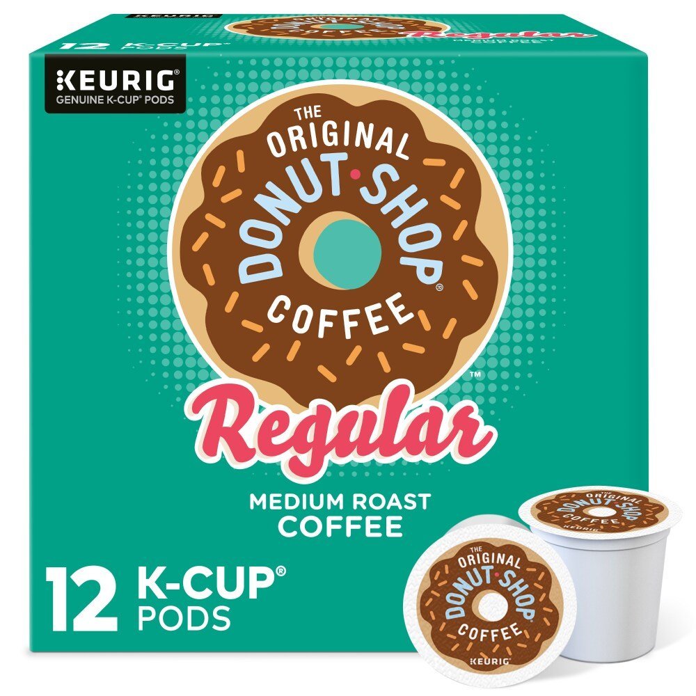 A cup of coffee next to a small amount of sugar and cream.