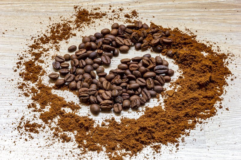 Essential coffee equipment including a burr grinder and scale for consistent coffee grounds.
