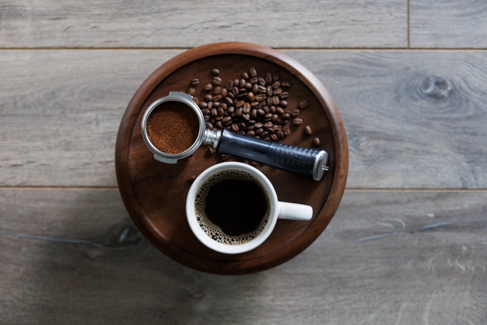 Essential tools for preparing fresh ground coffee displayed on a clean marble countertop.
