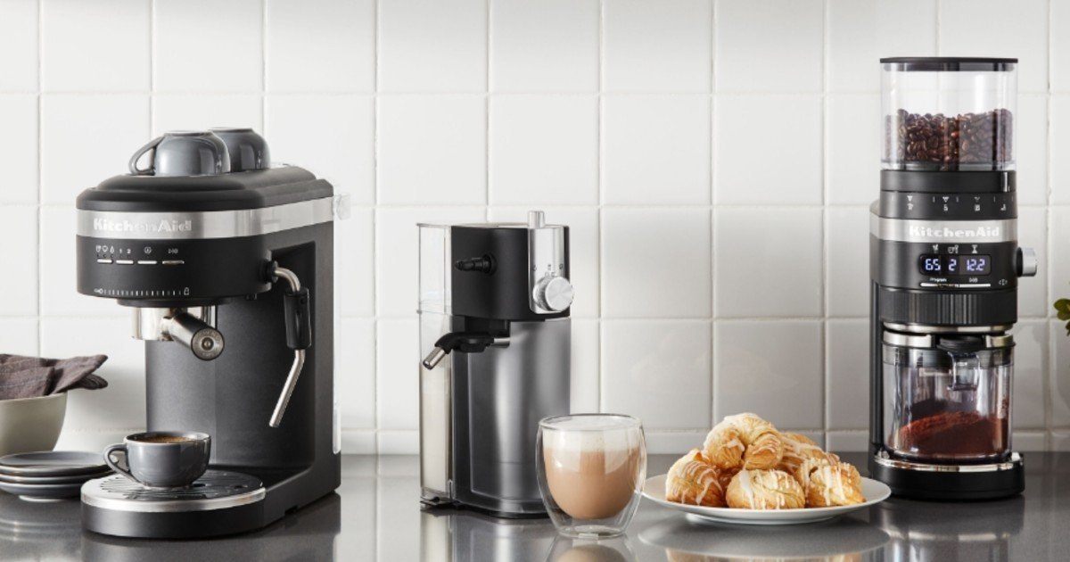 Rich, dark, and clumpy freshly ground coffee in a glass bowl showing signs of freshness.