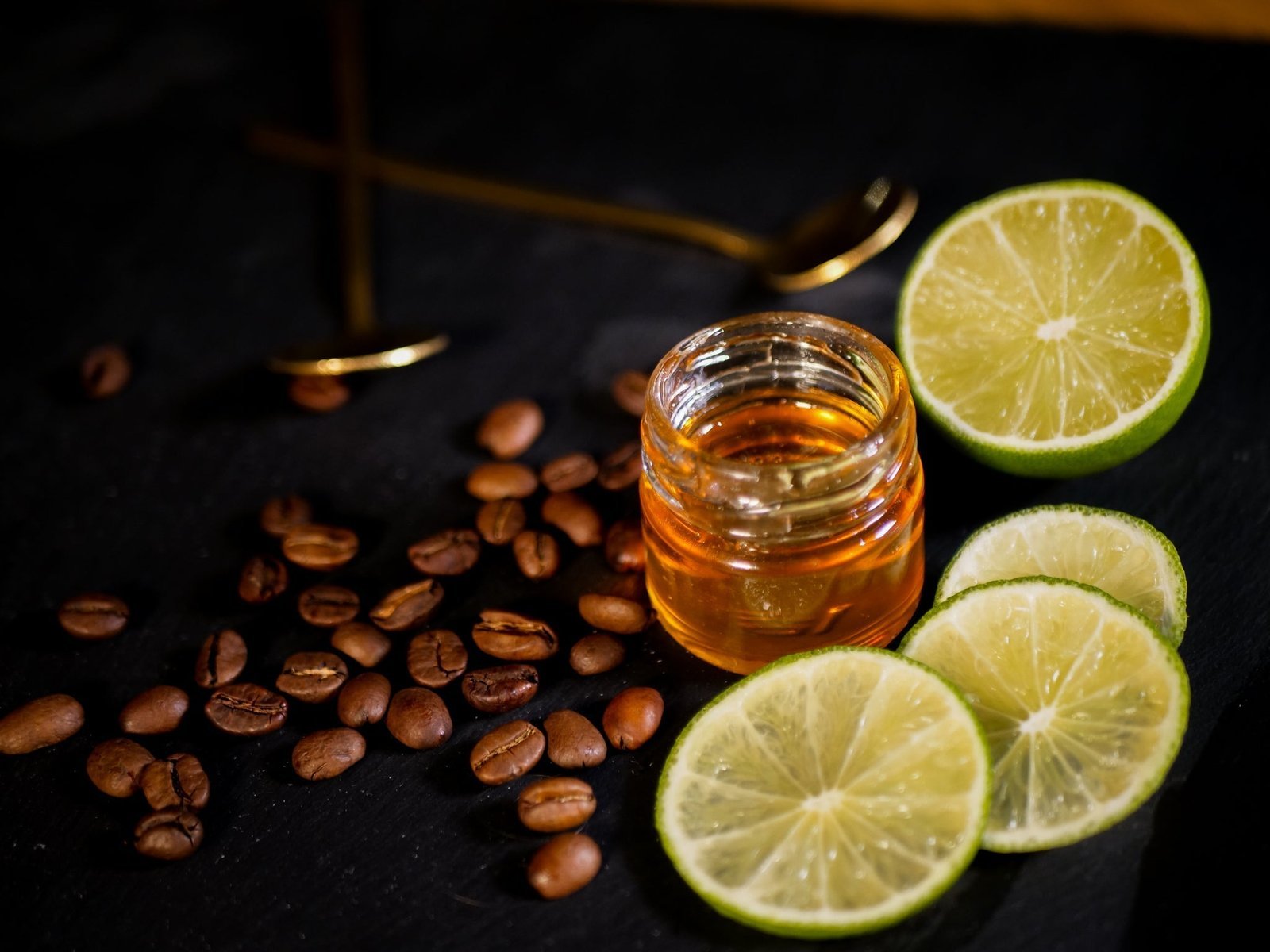 A clear glass mug of perfectly brewed coffee sitting on a linen cloth.