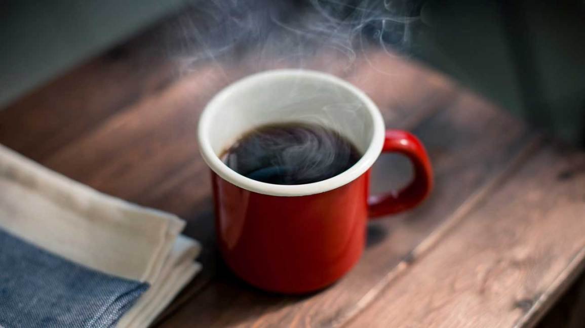 A serene coffee brewing setup on a wooden counter with soft morning light.