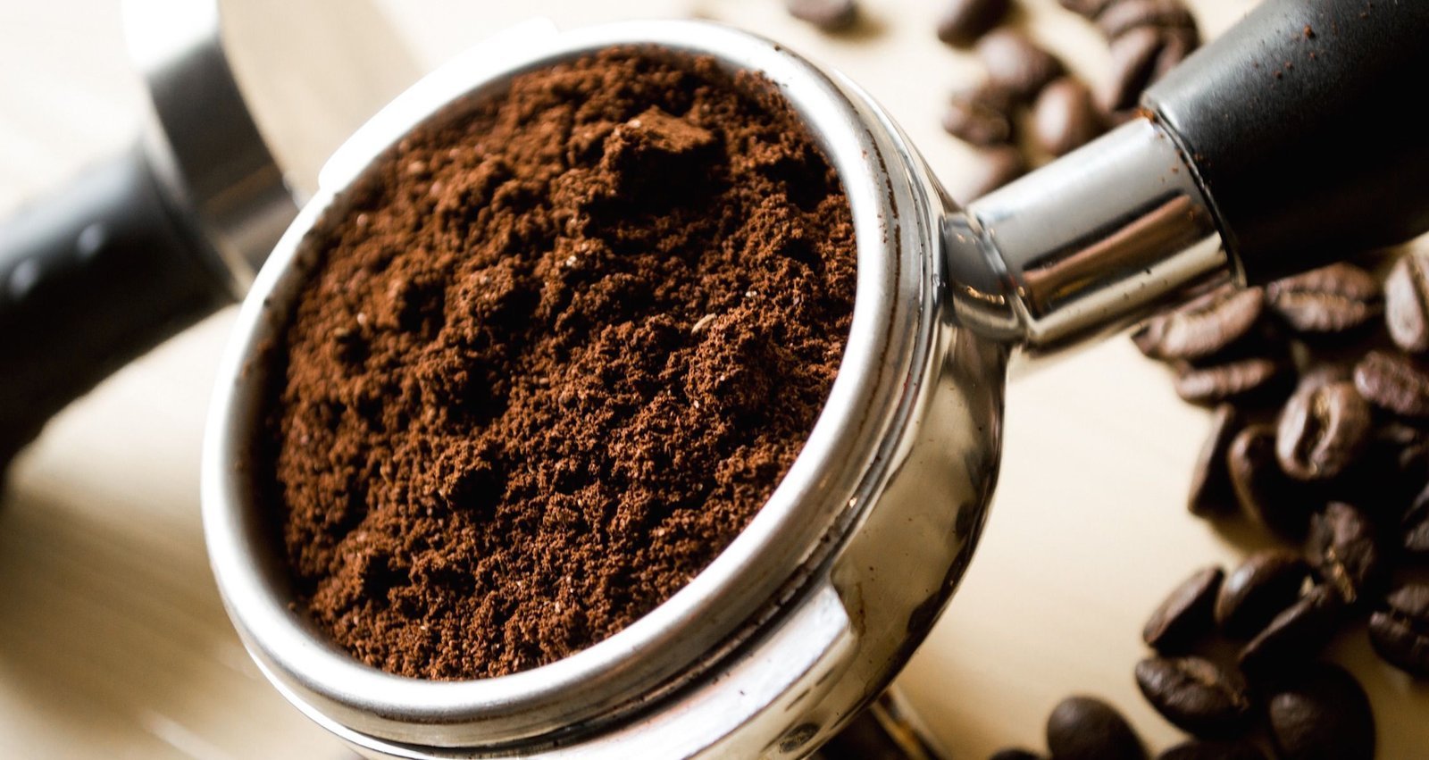 Professional burr grinder on a marble counter being adjusted for perfect coffee consistency.