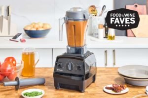 A modern blender filled with smooth onion paste on a bright kitchen counter.