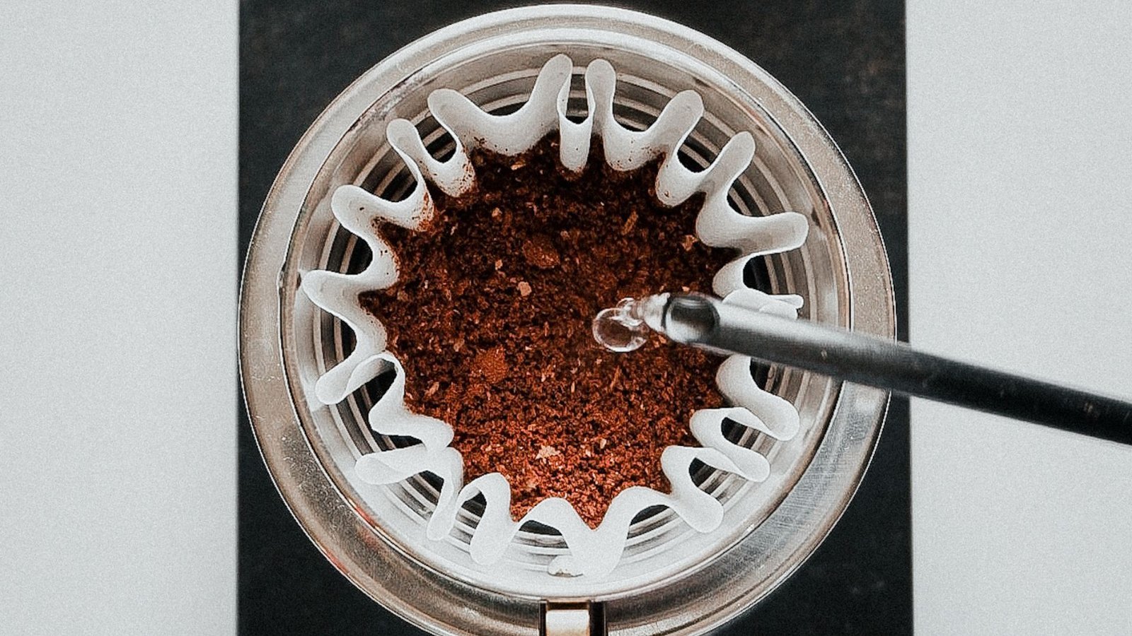 A clear glass mug contains perfectly brewed coffee with no visible sediment.
