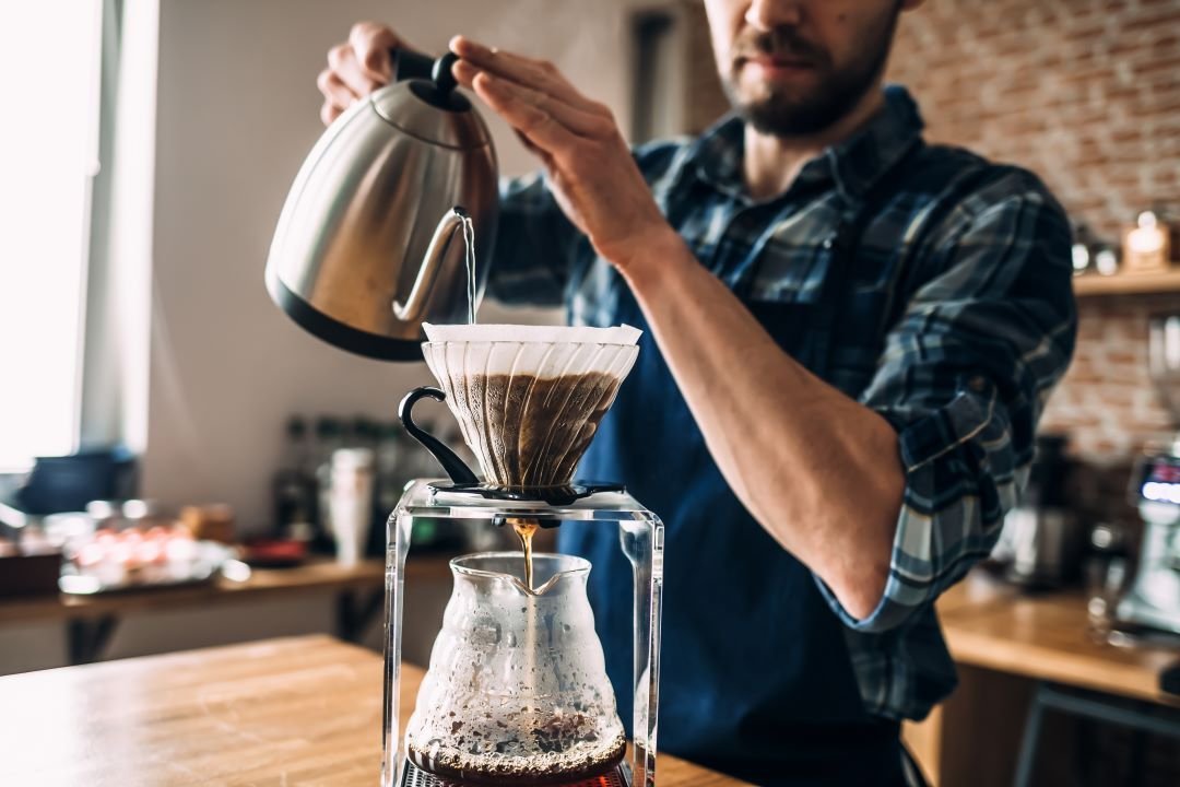 A clean coffee station with a scale and thermometer on a tray.