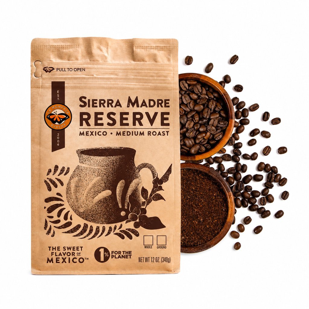A glass French press showing the finished coffee extraction and grounds.