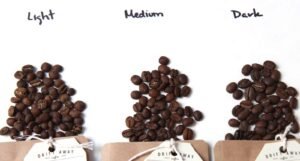 Medium roast and dark roast coffee beans displayed side by side for comparison.