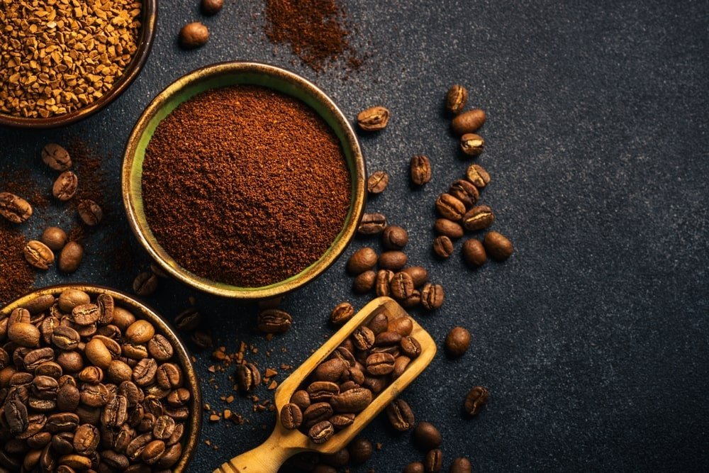 Two glass bowls showing different textures of ground coffee beans for brewing consistency.