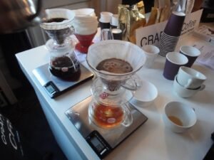 Assorted textures of ground coffee displayed on a wooden table for brewing preparation.