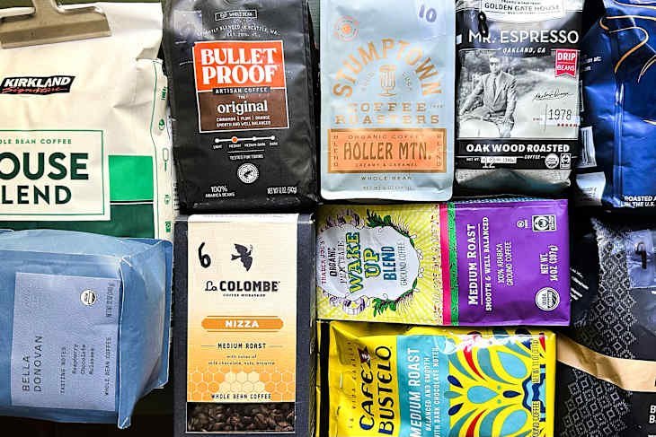 A selection of premium medium roast coffee bags and brewing equipment on a counter.