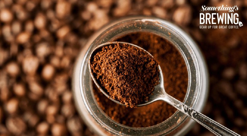 Macro view of uniform coffee grounds spread out to show consistent particle size.