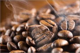 An assortment of fresh roasted coffee beans bags on a wooden counter.