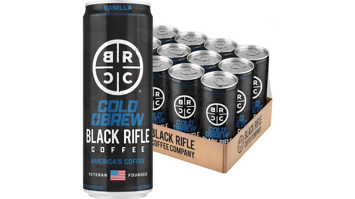 Glass jar of Black Rifle cold brew coffee on a wooden kitchen counter.