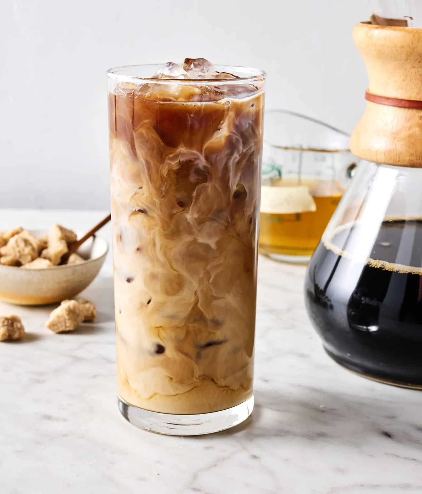 A glass jar of cloudy spoiled cold brew sitting on a kitchen counter.