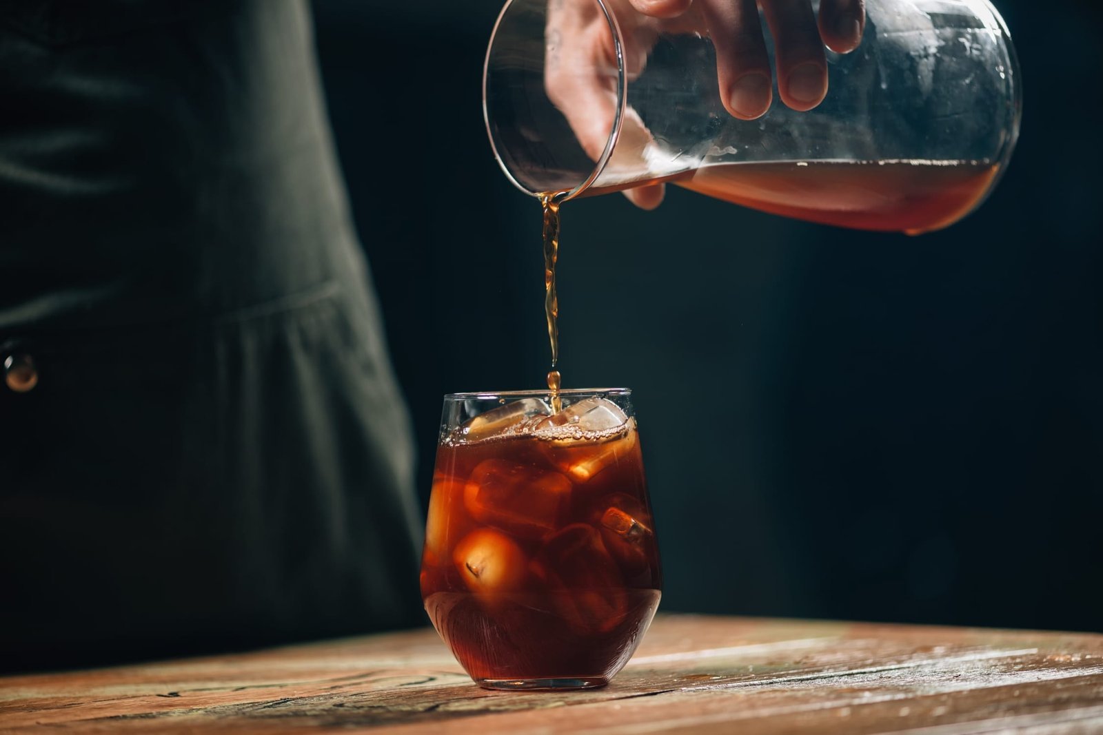 A glass jar of cold brew coffee steeping on a marble counter.