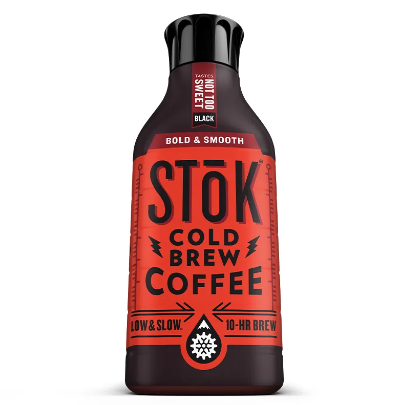 A glass pitcher of concentrated cold brew coffee sitting on a kitchen scale.