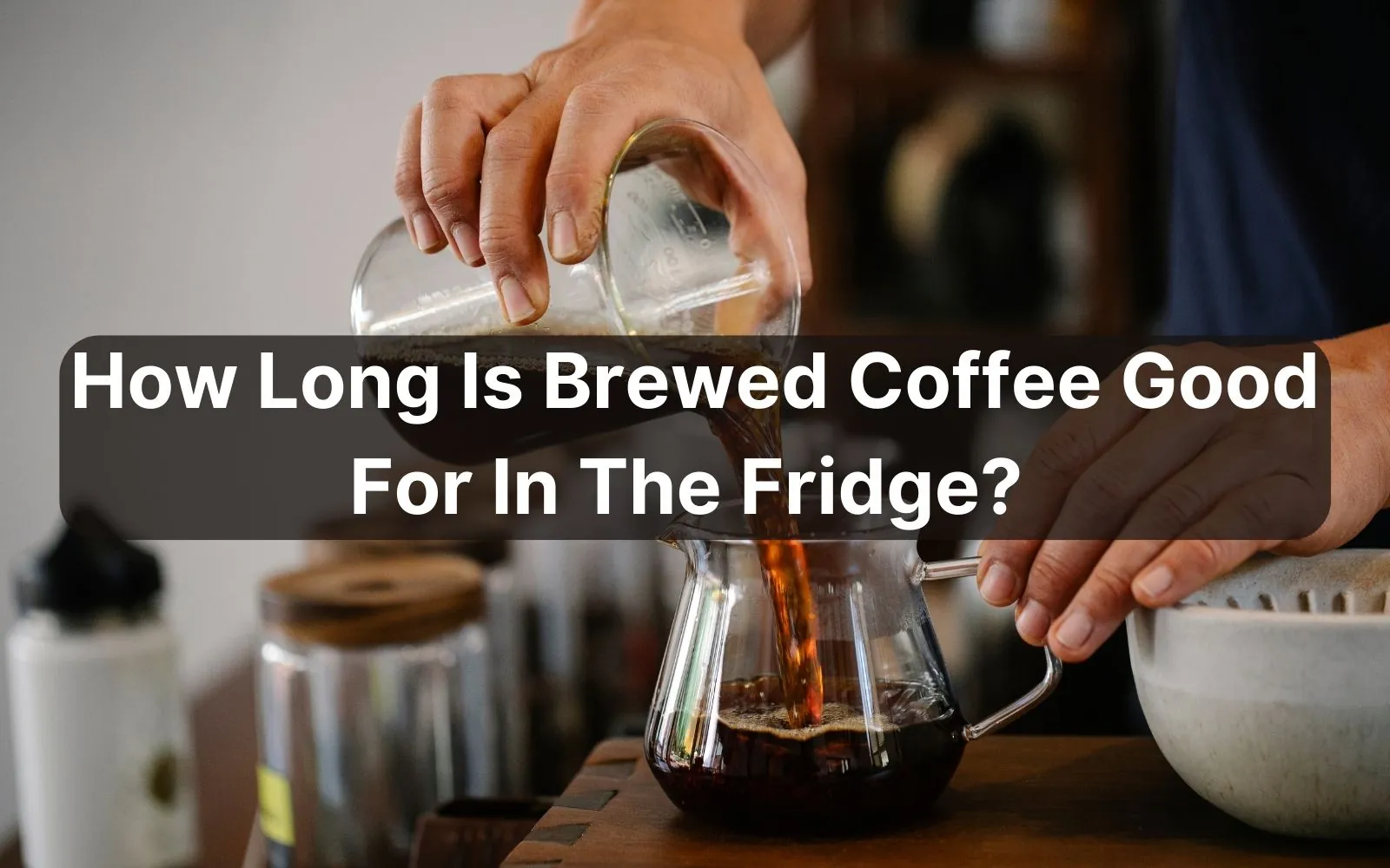 Sealed glass jar of brewed coffee stored safely inside a refrigerator shelf.