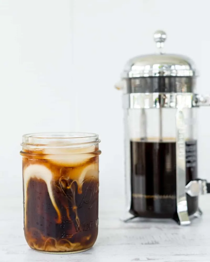 Spoiled batch of homemade cold brew sitting on a refrigerator shelf.