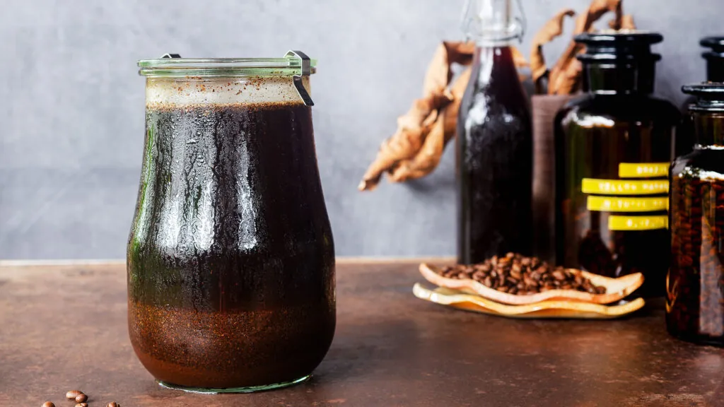 Three glasses showing different roast levels of cold brew coffee side by side.